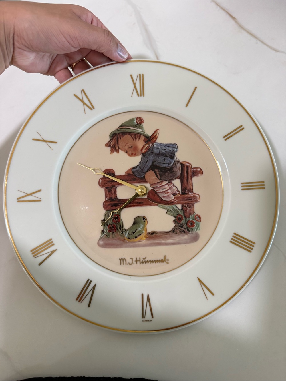 Hummel White and Gold Ceramic Wall Clock with Hand-Painted Boy and Bird